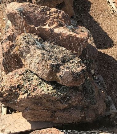 A pile of rocks sitting on top of each other in a cage.
