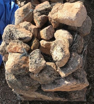 A pile of rocks sitting on top of each other on the ground.