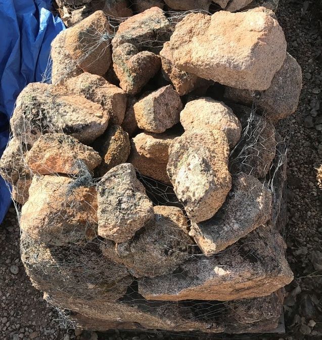 A pile of rocks sitting on top of a pile of gravel.