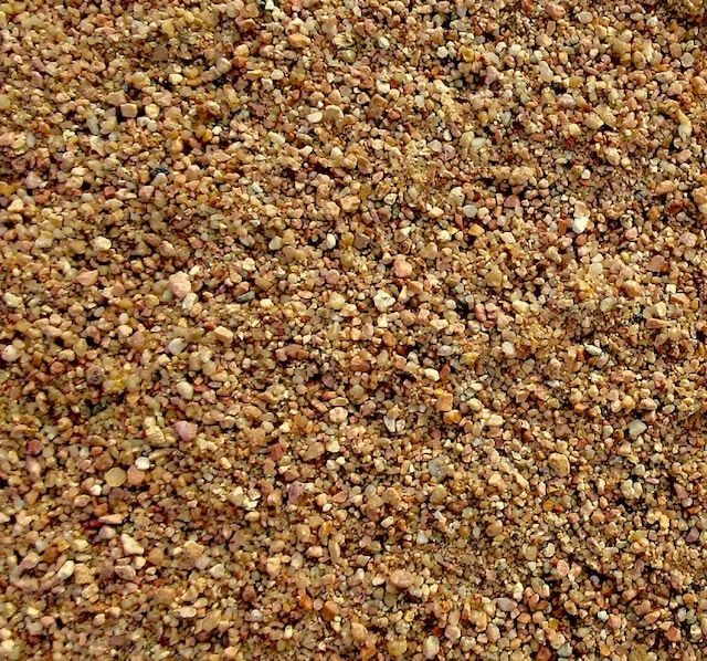 A close up of a pile of brown gravel.