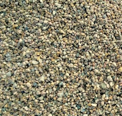 A pile of gravel is sitting on the ground.