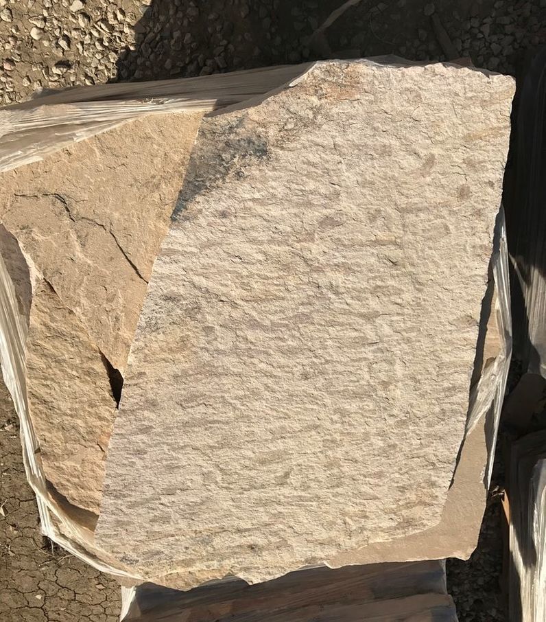 A large piece of rock is sitting on top of a pile of rocks.