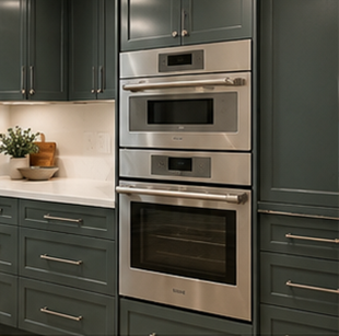 Built-in stainless steel oven and microwave in dark green kitchen cabinets