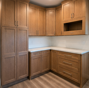 Empty wood kitchen with L-shaped white countertop and upper cabinets, including a built-in microwave nook