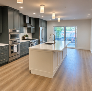 Modern kitchen with dark cabinets, large island, wood floors, and sliding glass doors to a patio