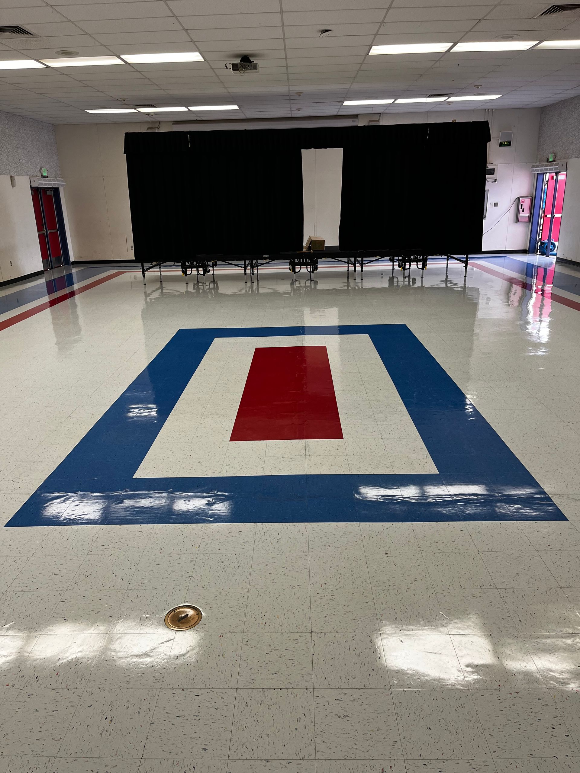 A large room with a red white and blue triangle on the floor