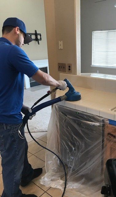 crew cleaning the counter grout