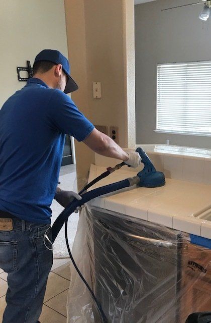 man cleaning the counter grout