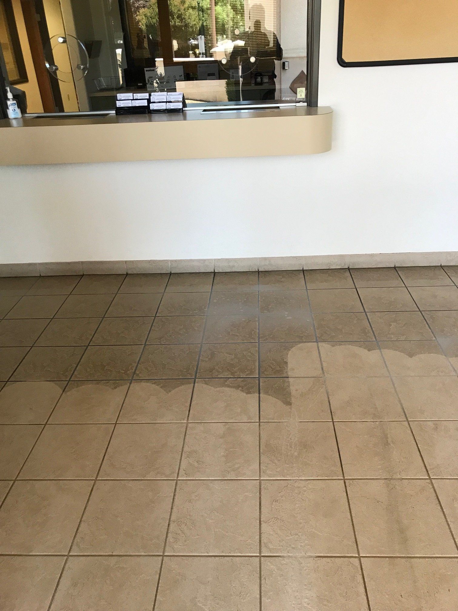 A tiled floor in a room with a white wall