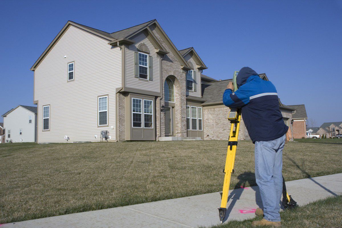 Man surveying residential property