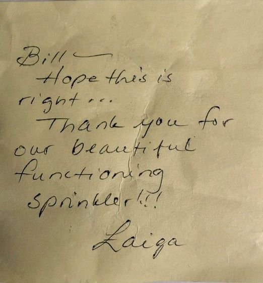 Handwritten note on paper: Bill, hope this is right. Thank you for our beautiful functioning sprinkler!! Laiga