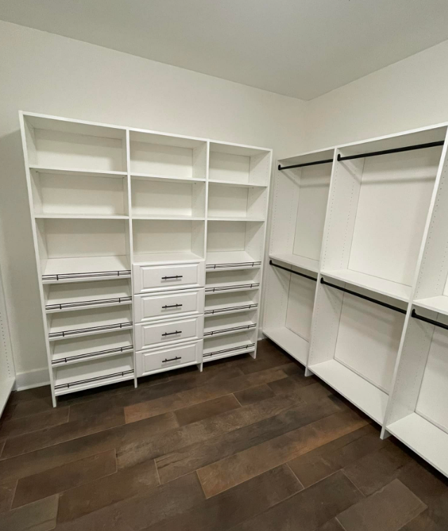 a walk in closet with lots of shelves and drawers