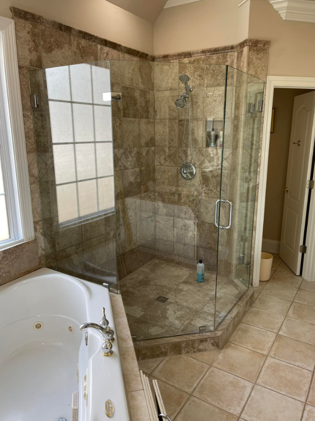 a bathroom with a walk in shower and a bathtub