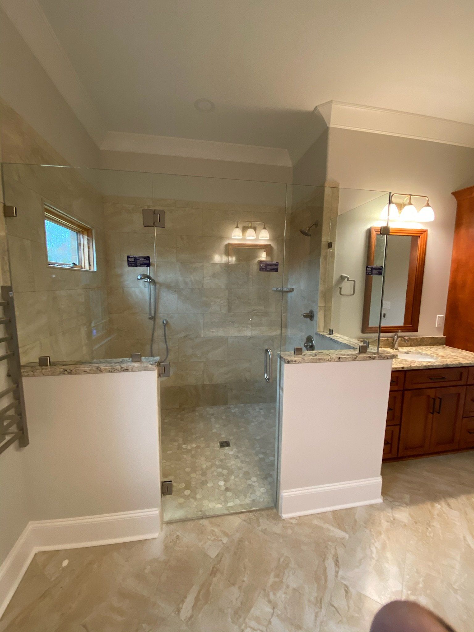 a bathroom with a walk in shower and a sink