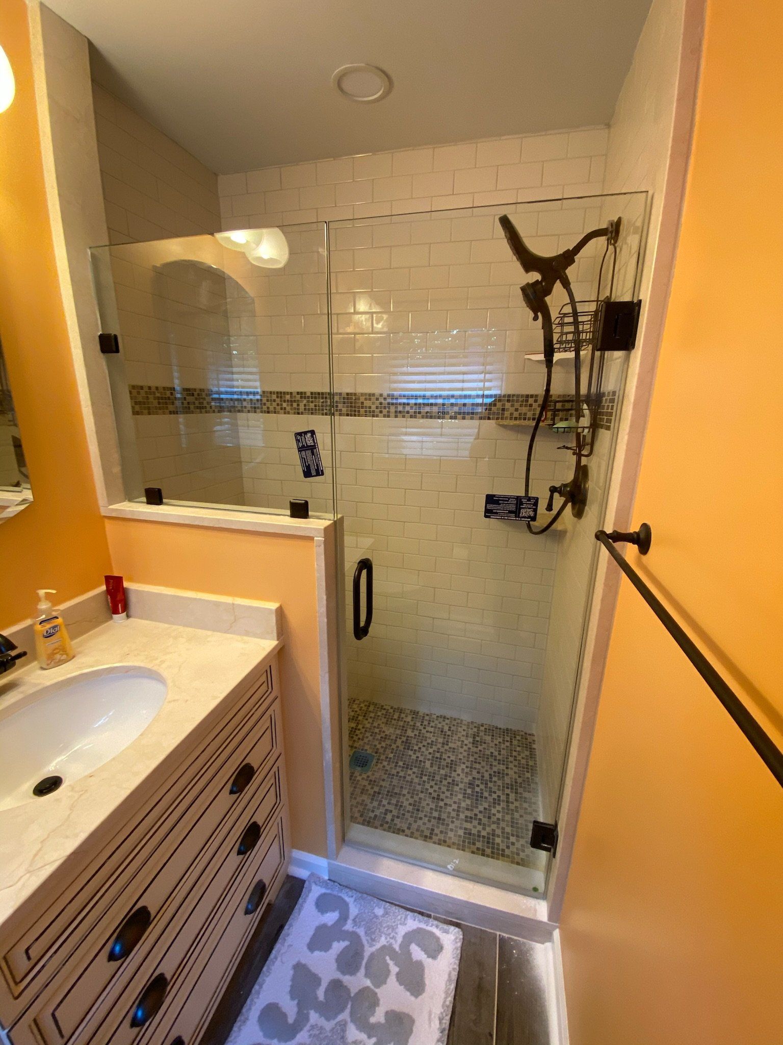 a shower with a frameless glass door