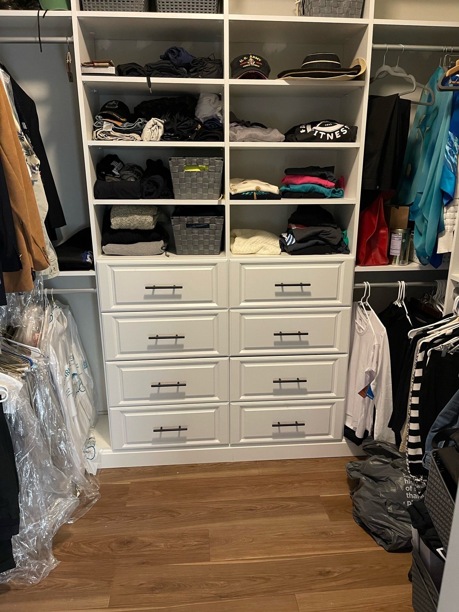 a walk in closet filled with lots of clothes and drawers