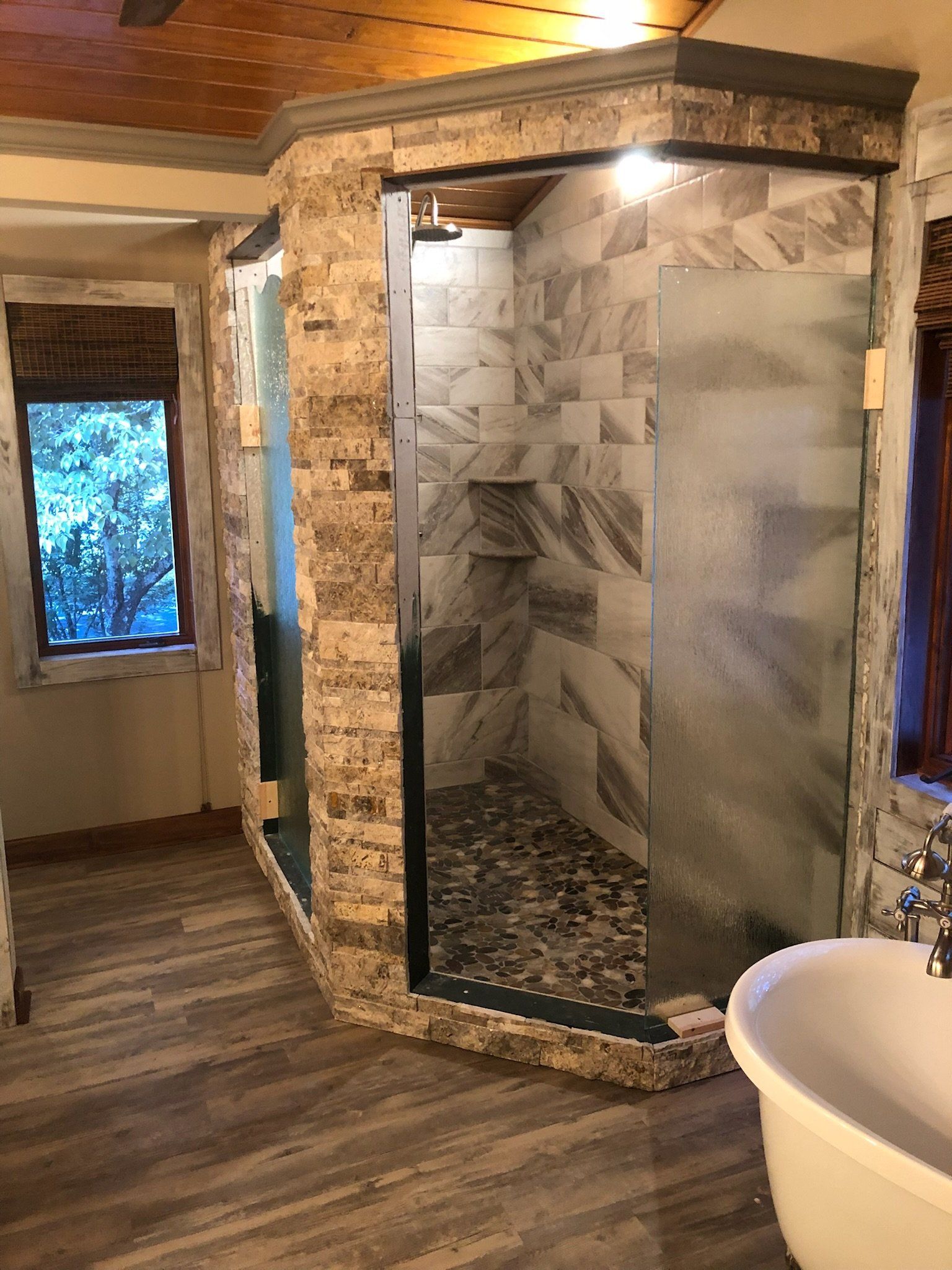 a bathroom with a walk in shower and a bathtub