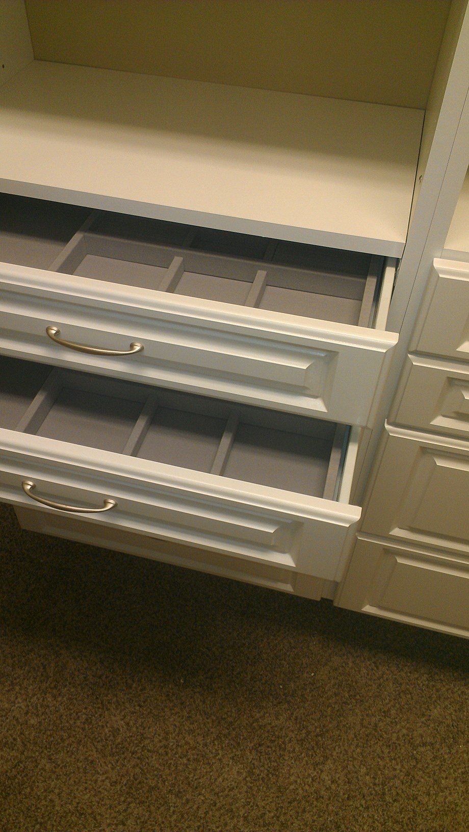 a close up of a closet with drawers open