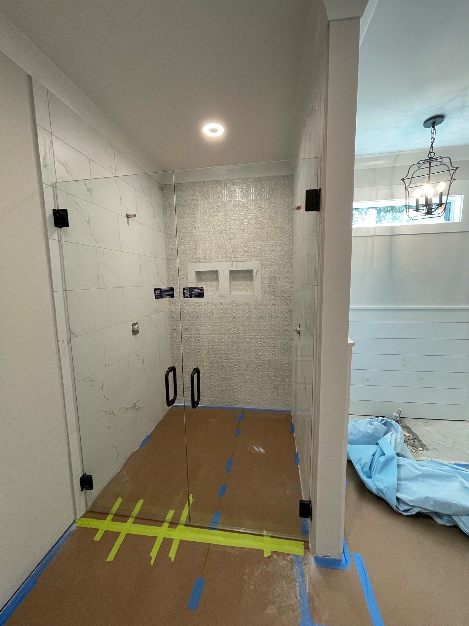 a shower stall is being remodeled