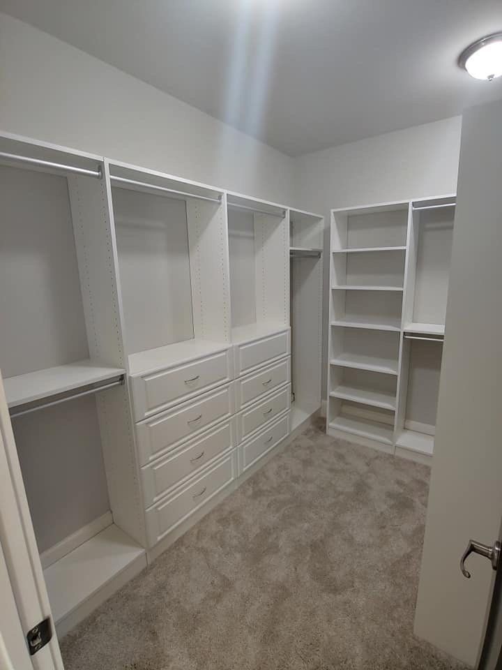 a custom closet with lots of shelves and drawers