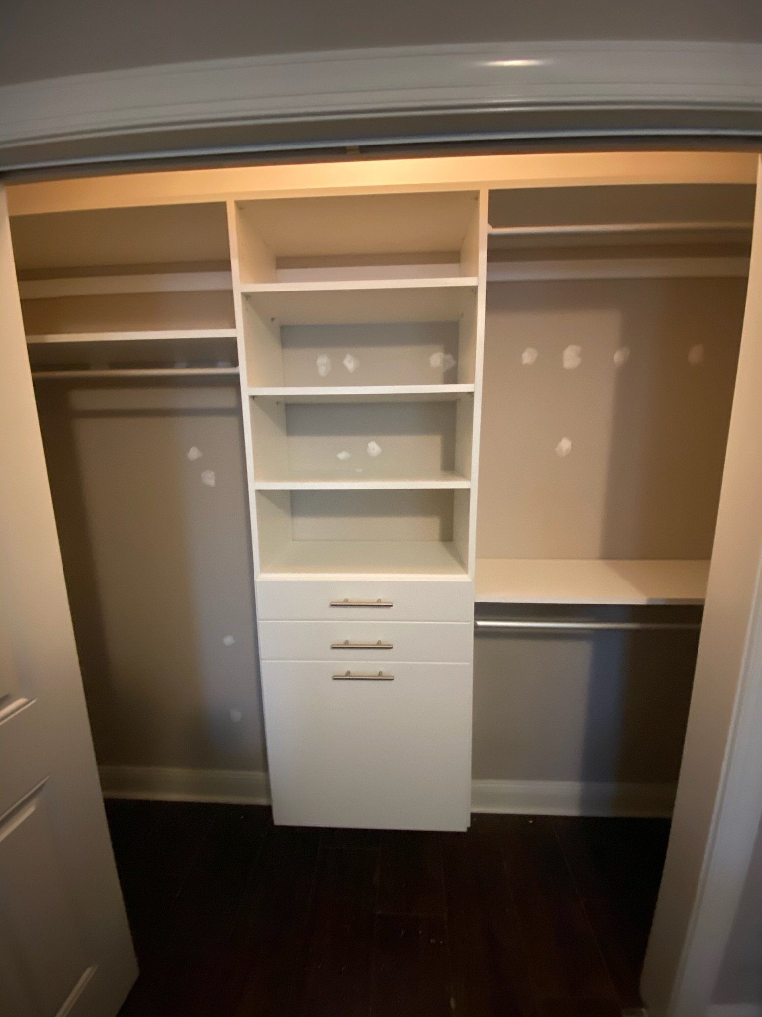 a closet with a lot of shelves and drawers