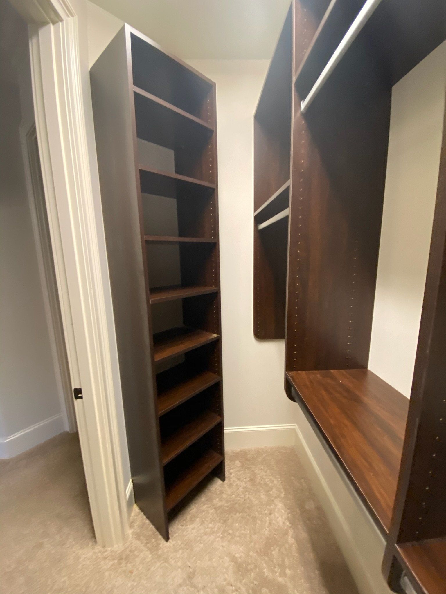 a walk in closet with lots of shelves