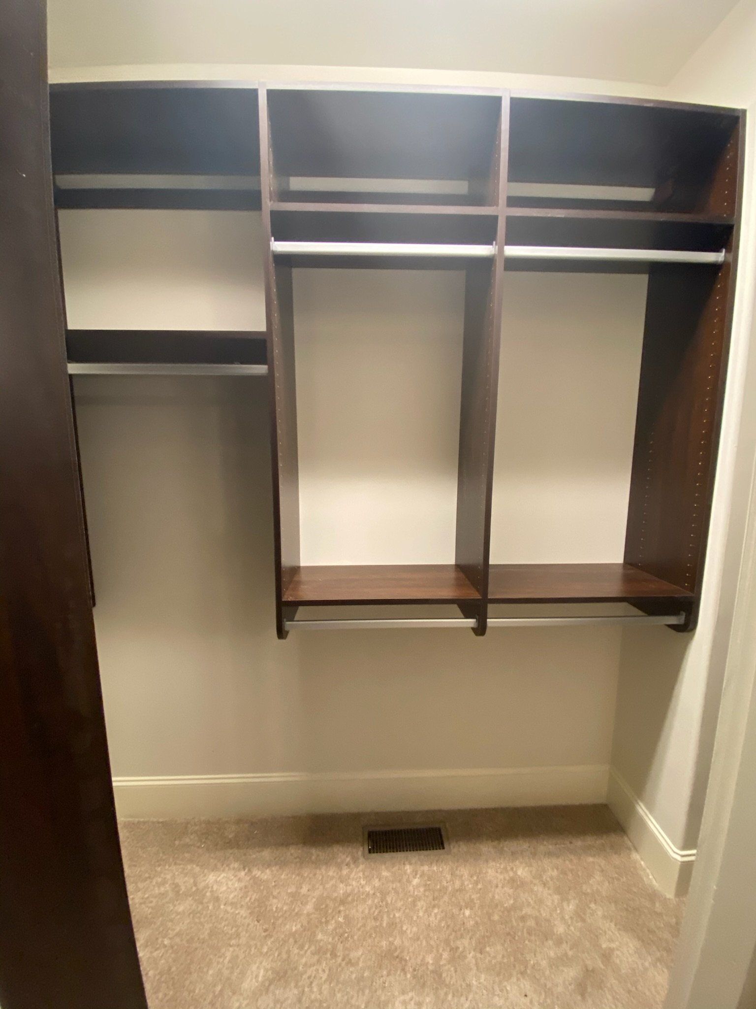 a walk in closet with lots of shelves