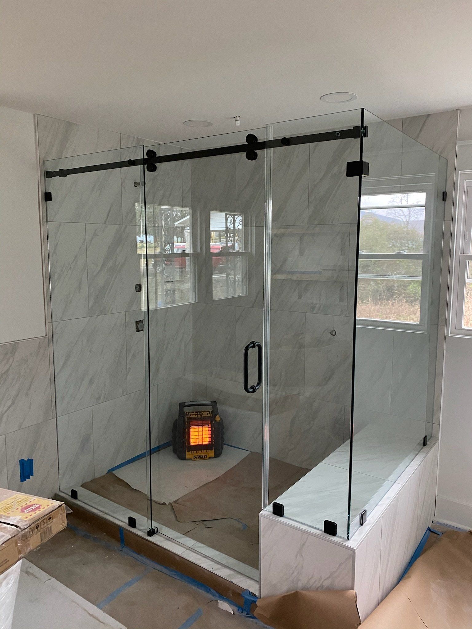 a stylish shower with a frameless shower door