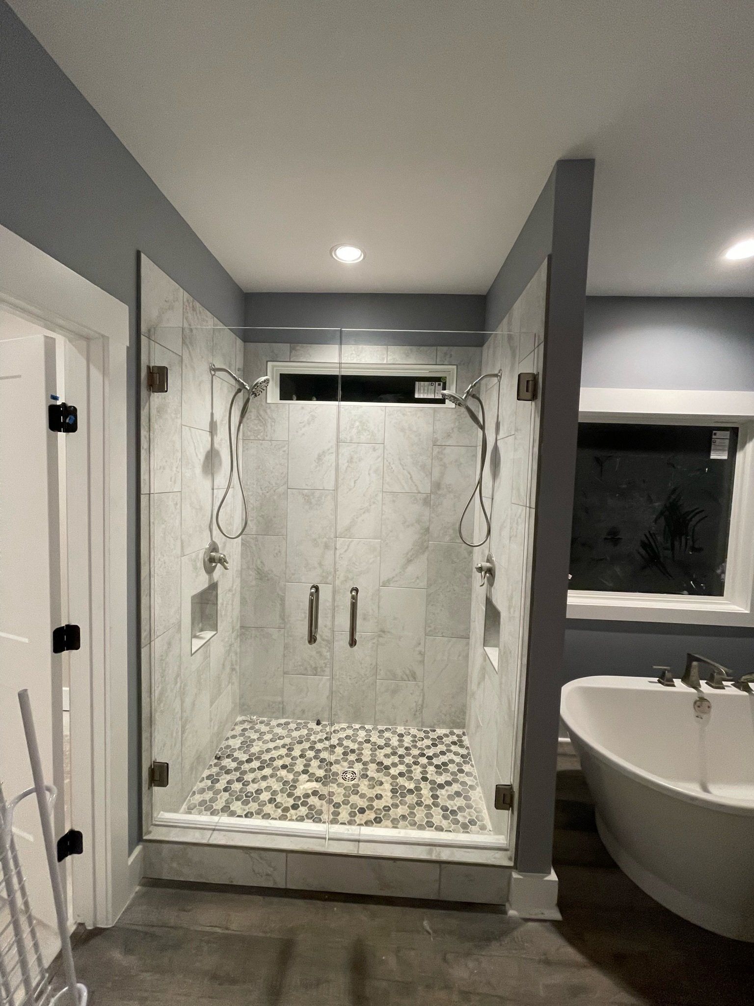 a bathroom with a walk in shower and a bathtub