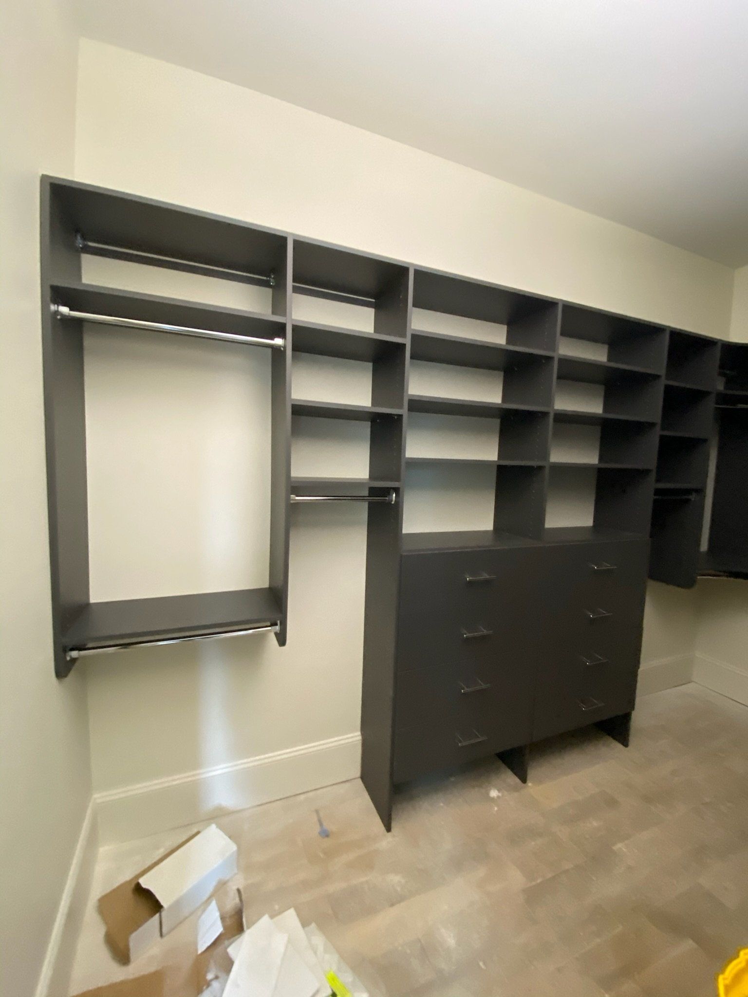 a walk in closet with lots of shelves and drawers
