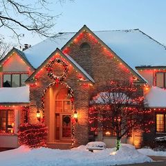 A house is decorated with Christmas lights and a wreath