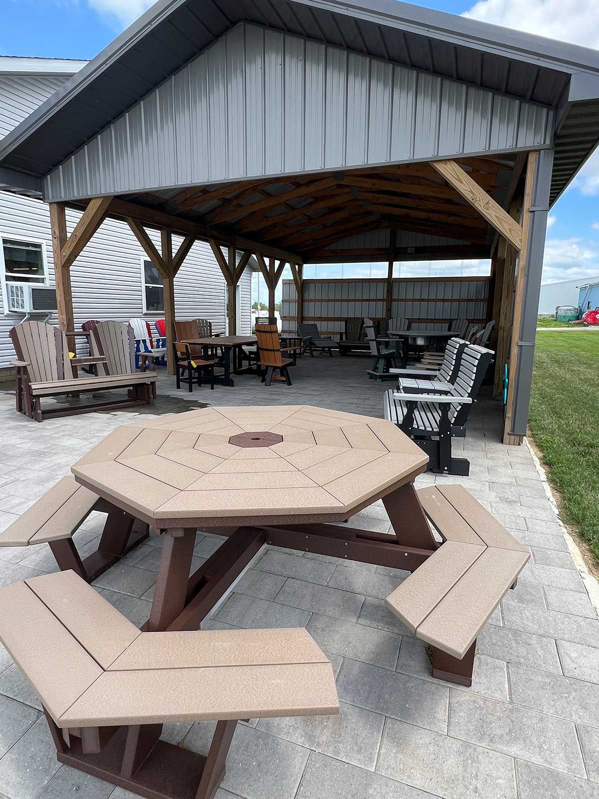 A picnic table with benches under a gazebo.