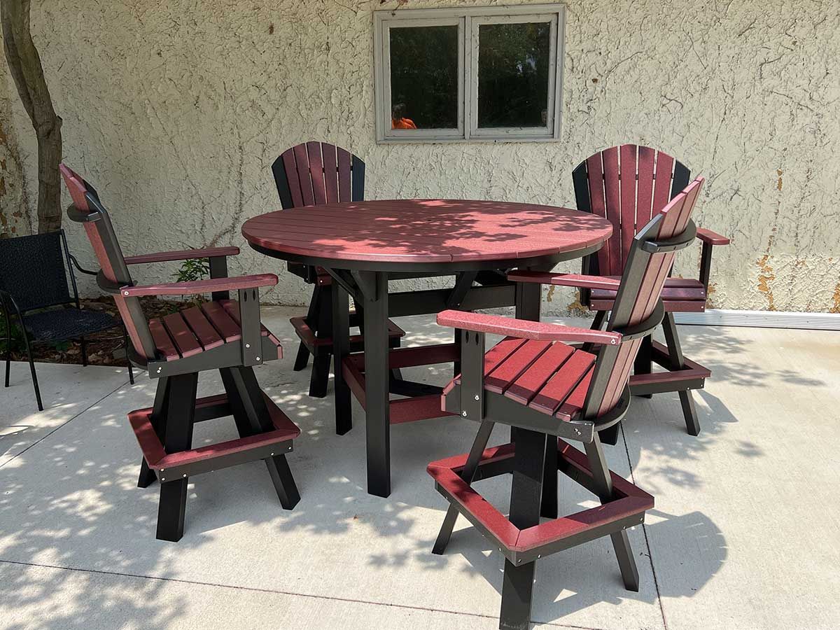 A table and chairs are sitting on a patio in front of a building.