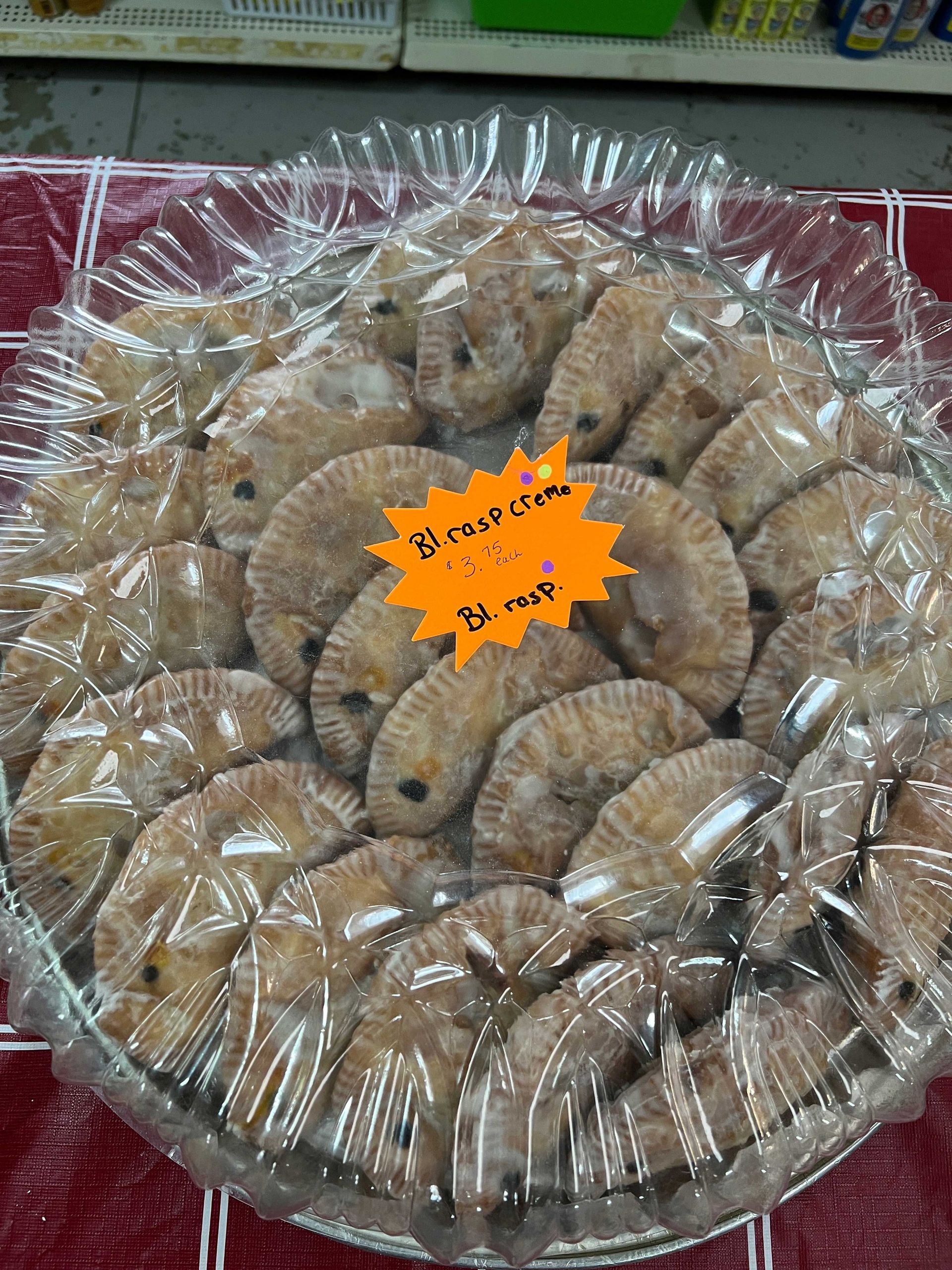 A tray of pineapples with a price tag on it