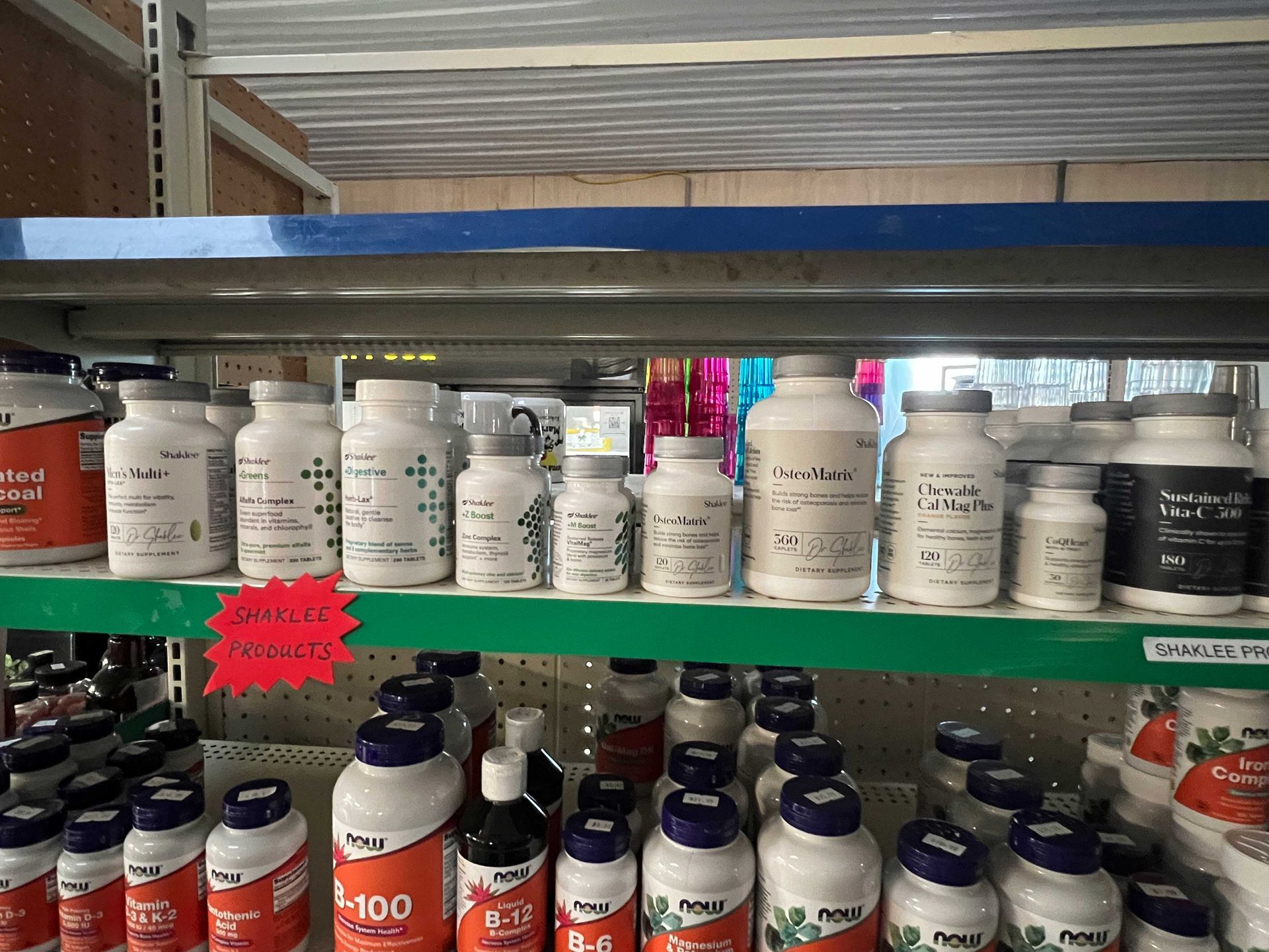 A shelf filled with lots of bottles of vitamins and supplements.