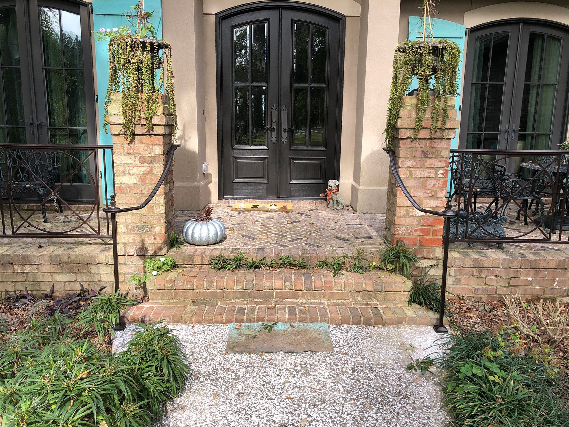There is a pumpkin on the porch of a house.