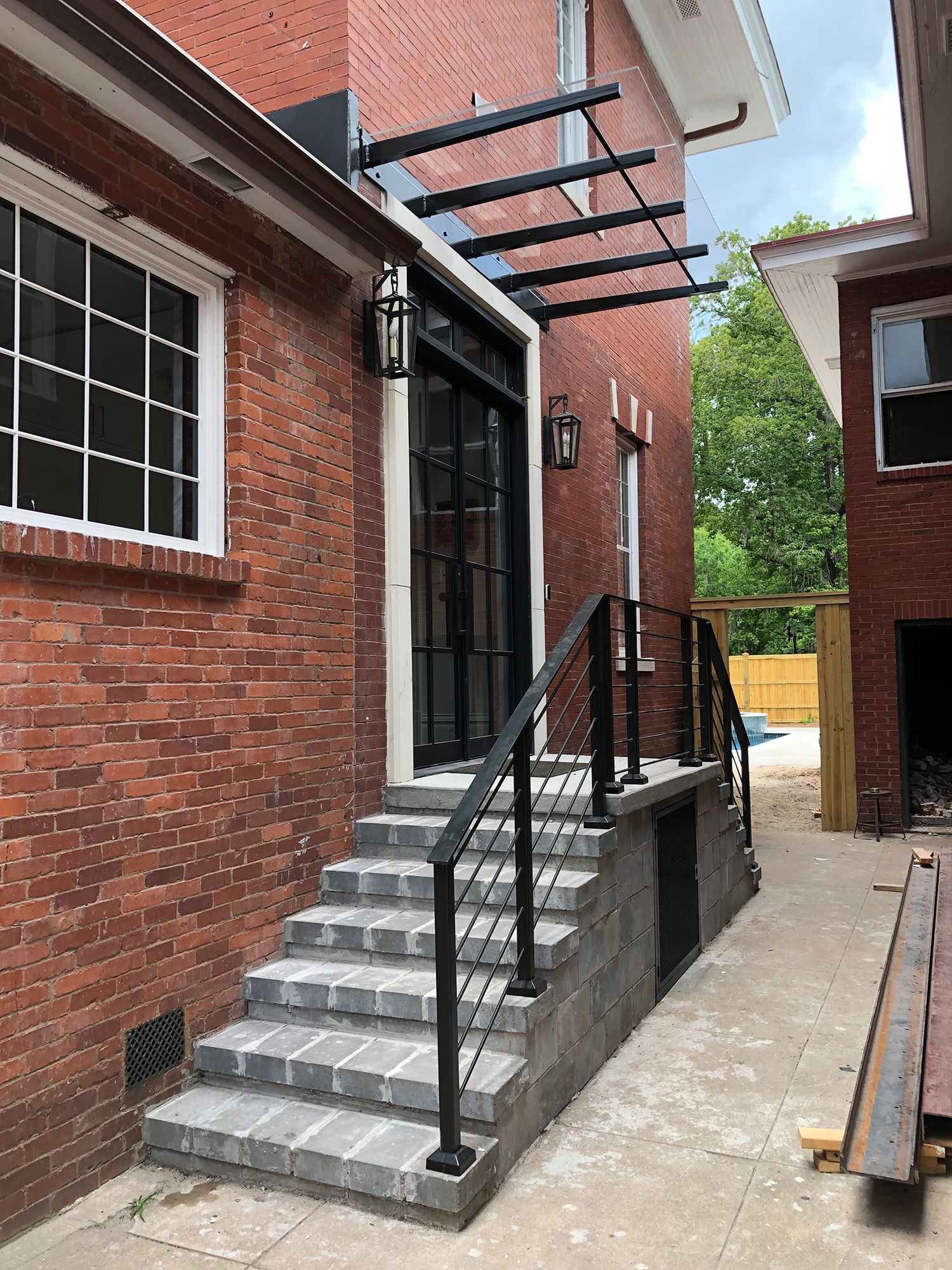 A brick building with stairs leading up to the front door.