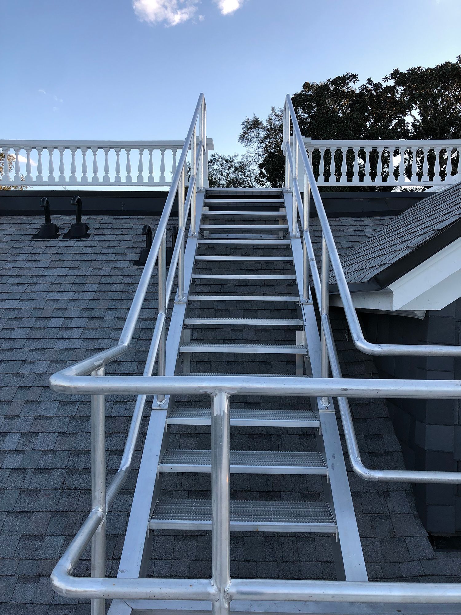 A set of stairs leading up to a balcony on top of a building.