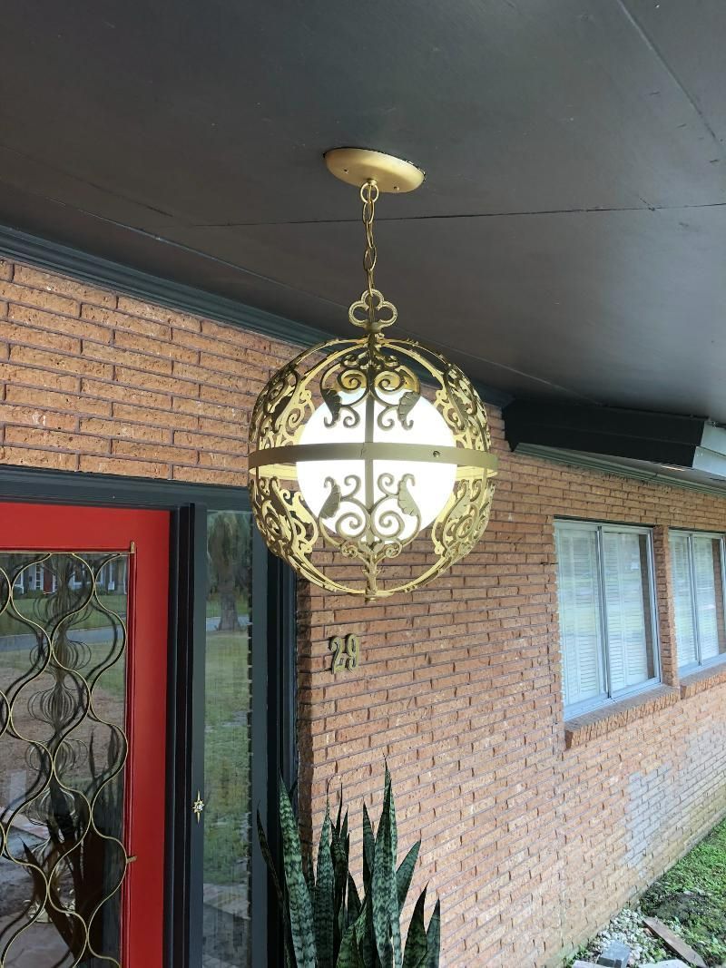 A pendant light is hanging from the ceiling of a brick building.
