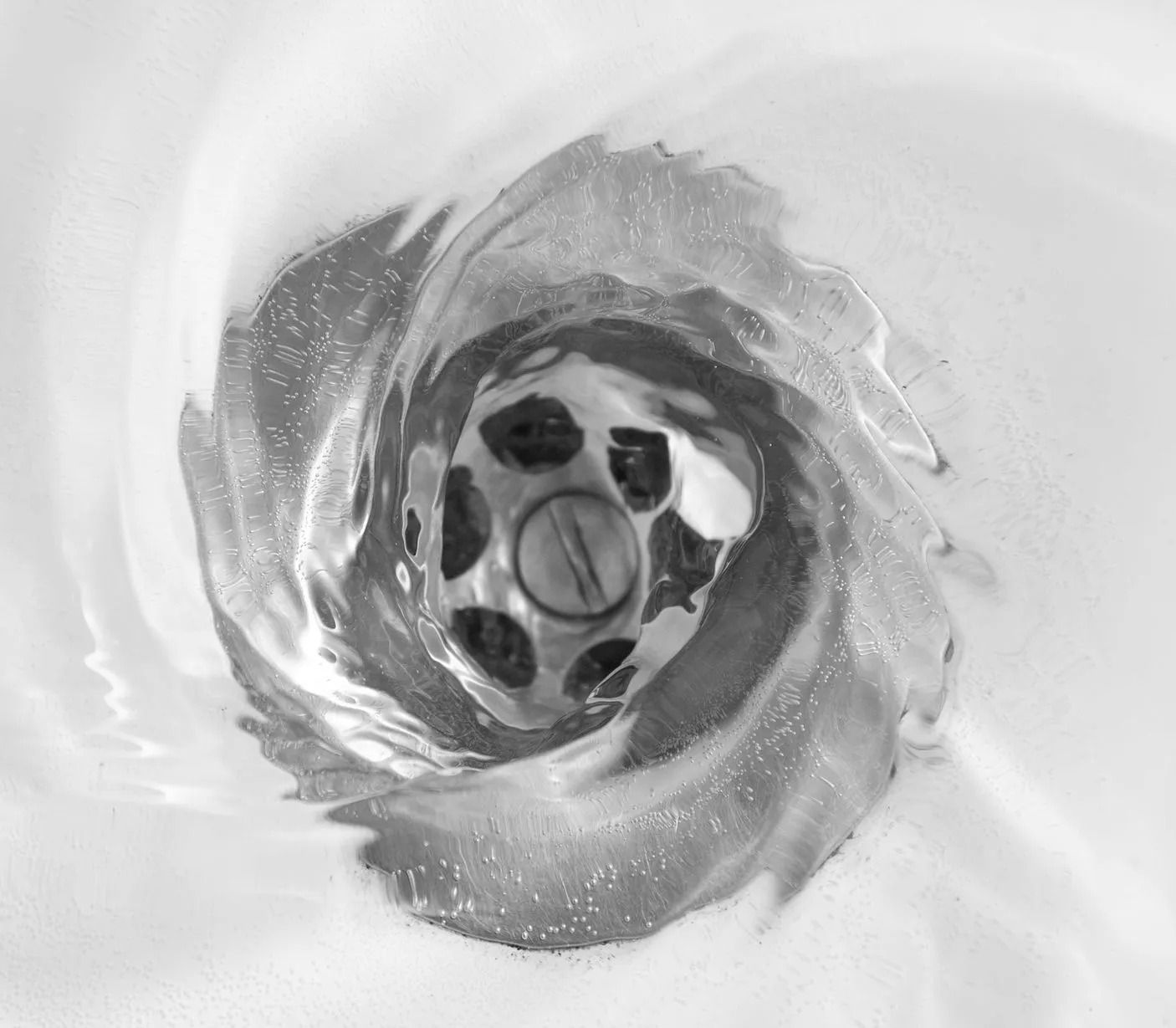 Water swirling down a bathroom sink drain.