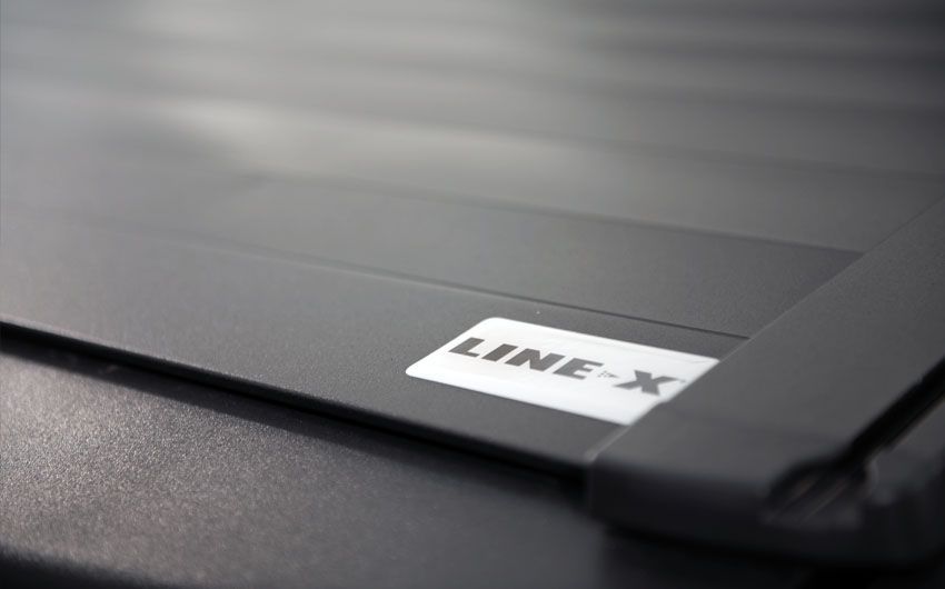 A close up of a line x sticker on a black surface