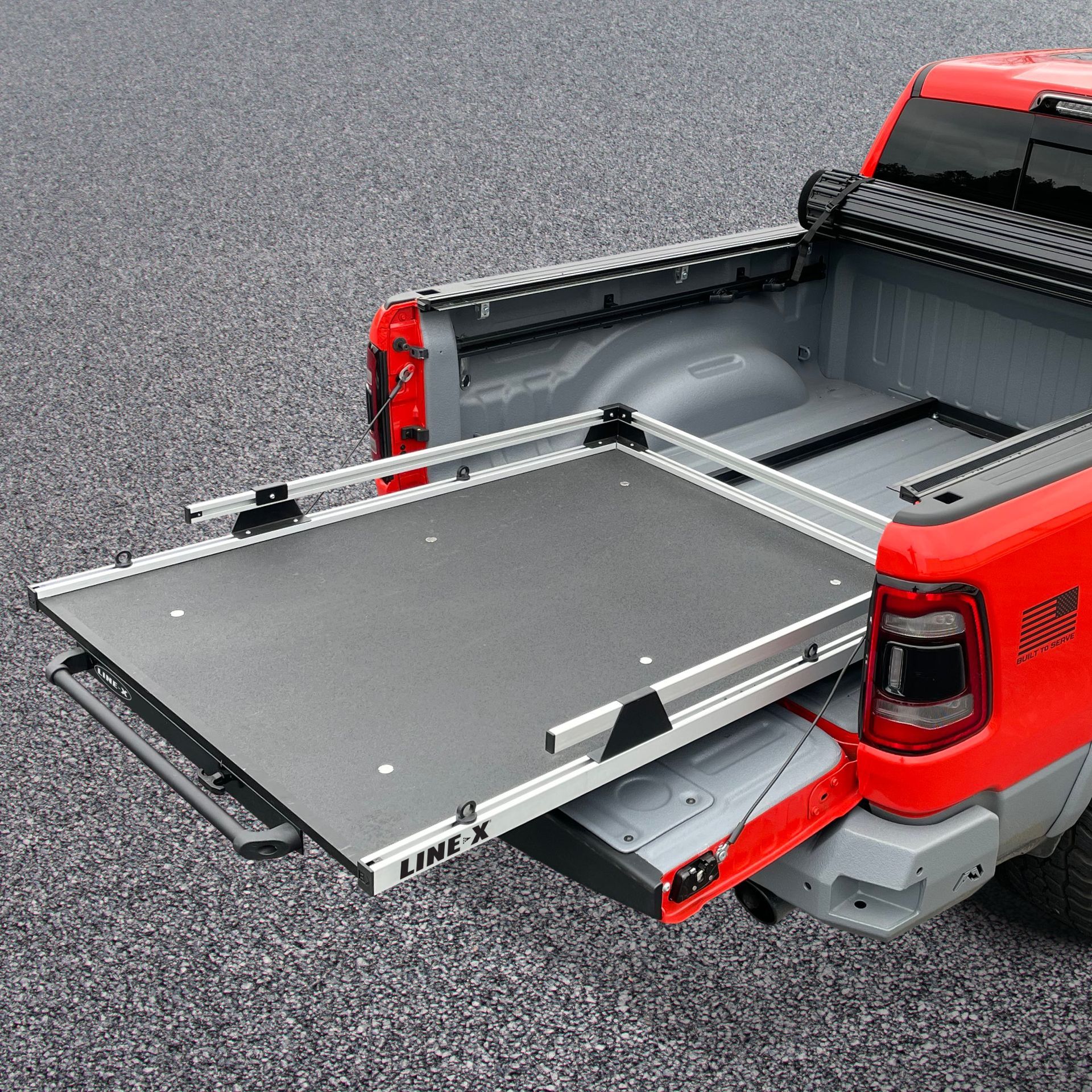 The back of a red truck with a slide out bed