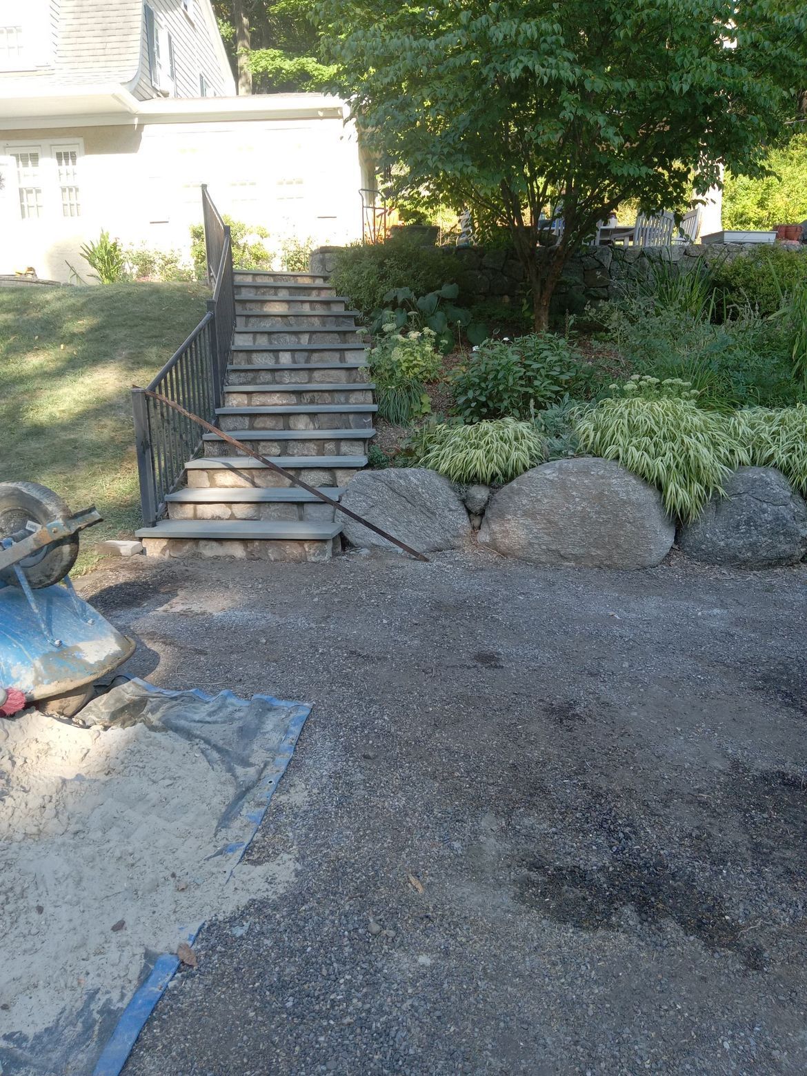 A set of stairs leading up to a house in a garden.