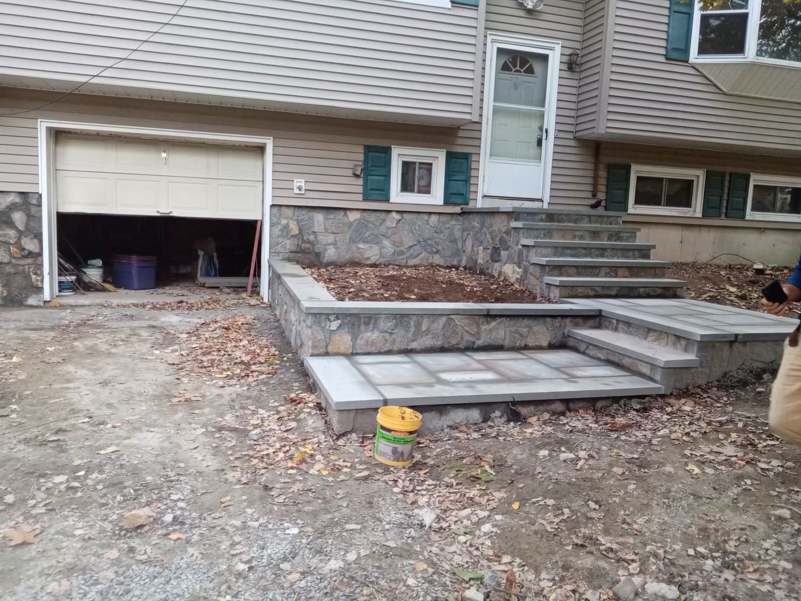 A house with a garage and stairs leading up to it