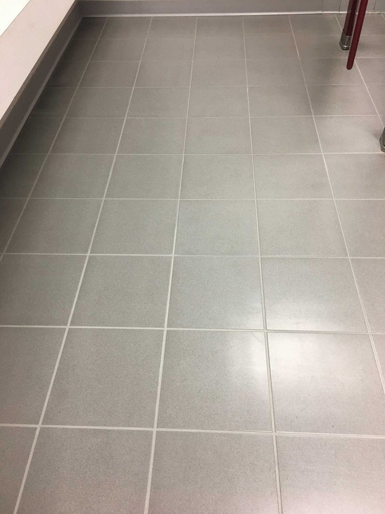 Gray tiled floor with white grout lines.