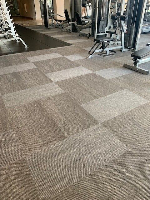 Gym floor with a checkered pattern and exercise equipment.