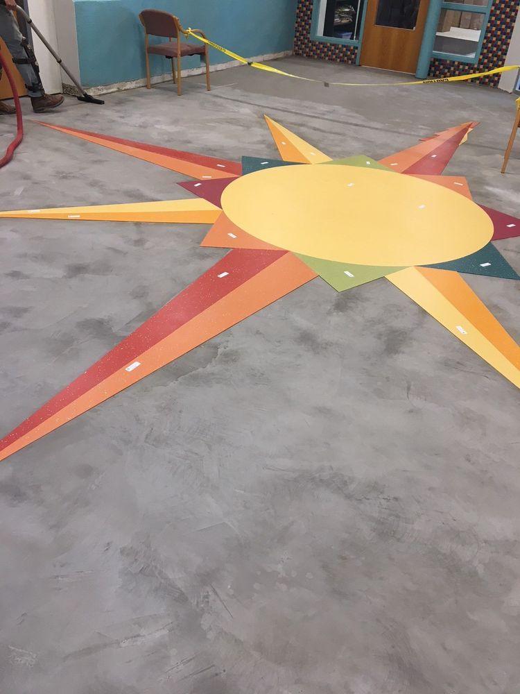 Colorful starburst design on a gray floor.