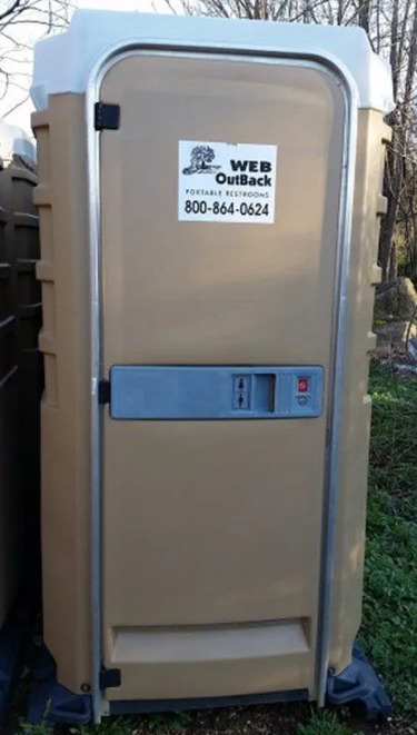Tan portable toilet with white top. 