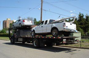 Two vehicle being carried by a truck