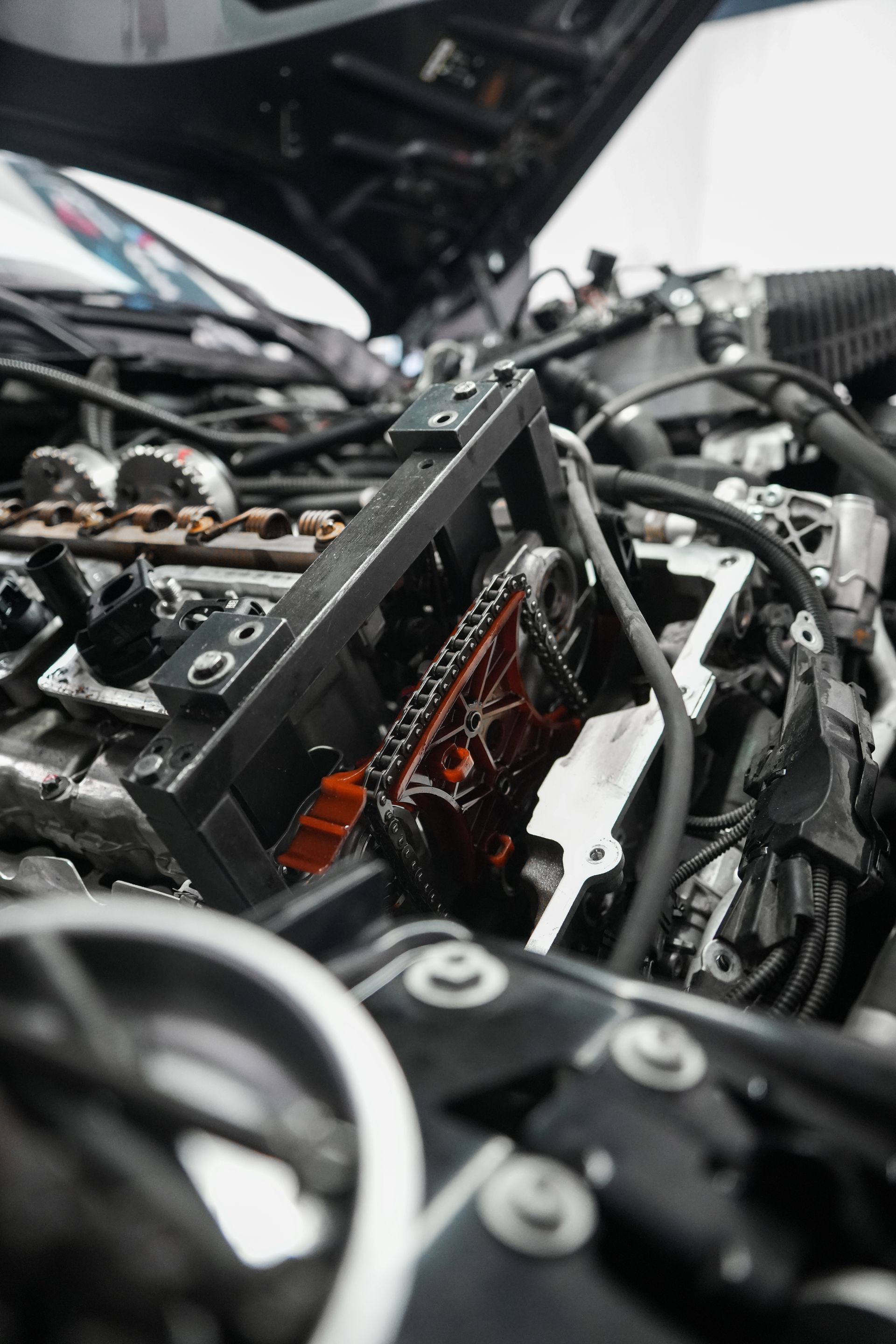 Close-up of tangled black and orange electronic wiring and components inside machinery